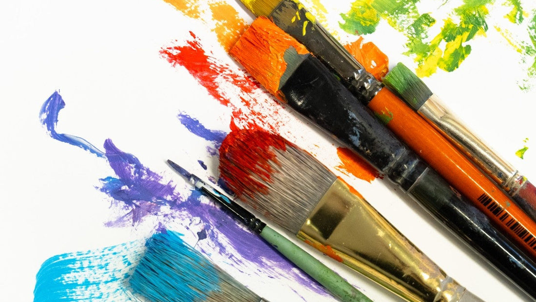Set of paintbrushes with colorful paint strokes on a white background